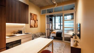 A modern kitchen with a built-in oven, a coffee machine, and a sink.