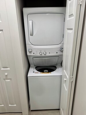 A compact, white, wall-mounted washer and dryer unit with a control panel featuring multiple dials and buttons. - Beautiful 2 bedroom/2 bath condo in Santa Rosa Beach (Santa Rosa Beach)