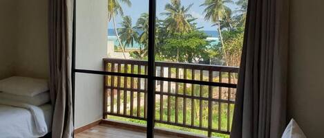 Deluxe Triple Room, Balcony, Partial Sea View | Minibar