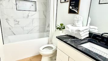 Shower, hair dryer, towels, toilet paper