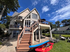 A multi-story house with a balcony, a staircase, and a kayak. - Lakeview on Magician- lakefront luxury (Dowagiac)