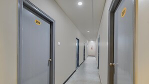 A hallway with doors numbered 209 and 201, leading to rooms. - Deluxe Room Adithya Stay (Hyderabad)