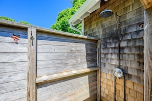 A wooden fence with a starfish decoration, a metal door with a handle, and a showerhead. - Cape Cod Cottage near Beaches & Downtown (Chatham)