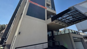 A modern building with a prominent sign for 'Galaxy Casino' and an 'Alta Tower' logo.