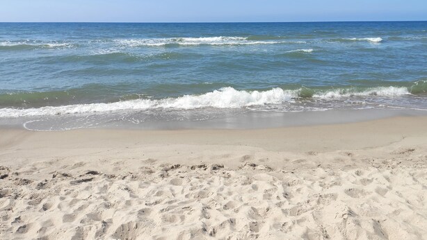 A sandy beach with gentle waves and a clear sky. - 2 bedroom lovely home in Rusinowo (Rusinowo)