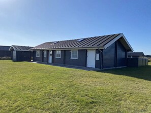 A single-story building with a gabled roof and a small attached garage. - 4 Star Holiday Home in Harboore (Harboore)