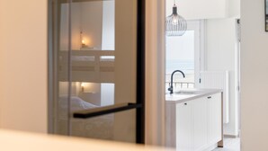 A modern interior with a kitchen area, a dining space, and a view of the sea. - Sea view and comfort in Middelkerke (Middelkerke)
