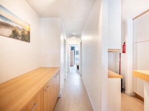 Ein schmaler Korridor mit Holzausbau und einem Bild an der Wand.