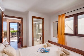 A hotel room with a bed, a bathroom, and a view of the outside. - Pool House Suzi in Heart of Istria (Barban)