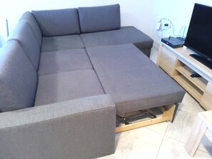A sectional sofa with a TV stand and cable management. - 3 rooms by the Black Sea (Sonnenstrand)