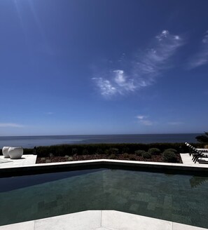 A clear sky, a swimming pool, and a view of the ocean. - Serene Suite w/ Balcony & Ocean View, Perfect for a Quiet Retreat (Lagos)
