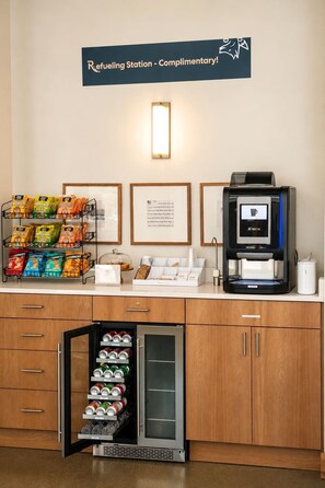 A refueling station with snacks, a coffee machine, and a refrigerator. - Roami at Studio 135 - Stylish Studio | 2 units (Denver)