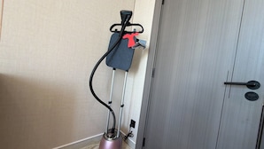 A vacuum cleaner in a corner with a door nearby. - 402 tara-JRE Jabal Al Lweibdeh with stunning view (Amman)