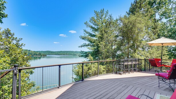A deck with a view of a lake, outdoor furniture, and a railing. - Decked Out! Private Dock Escape on Watts Bar Lake (Spring City)