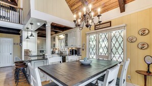 A spacious kitchen with a large island, white cabinetry, and a chandelier. - Decked Out! Private Dock Escape on Watts Bar Lake (Spring City)