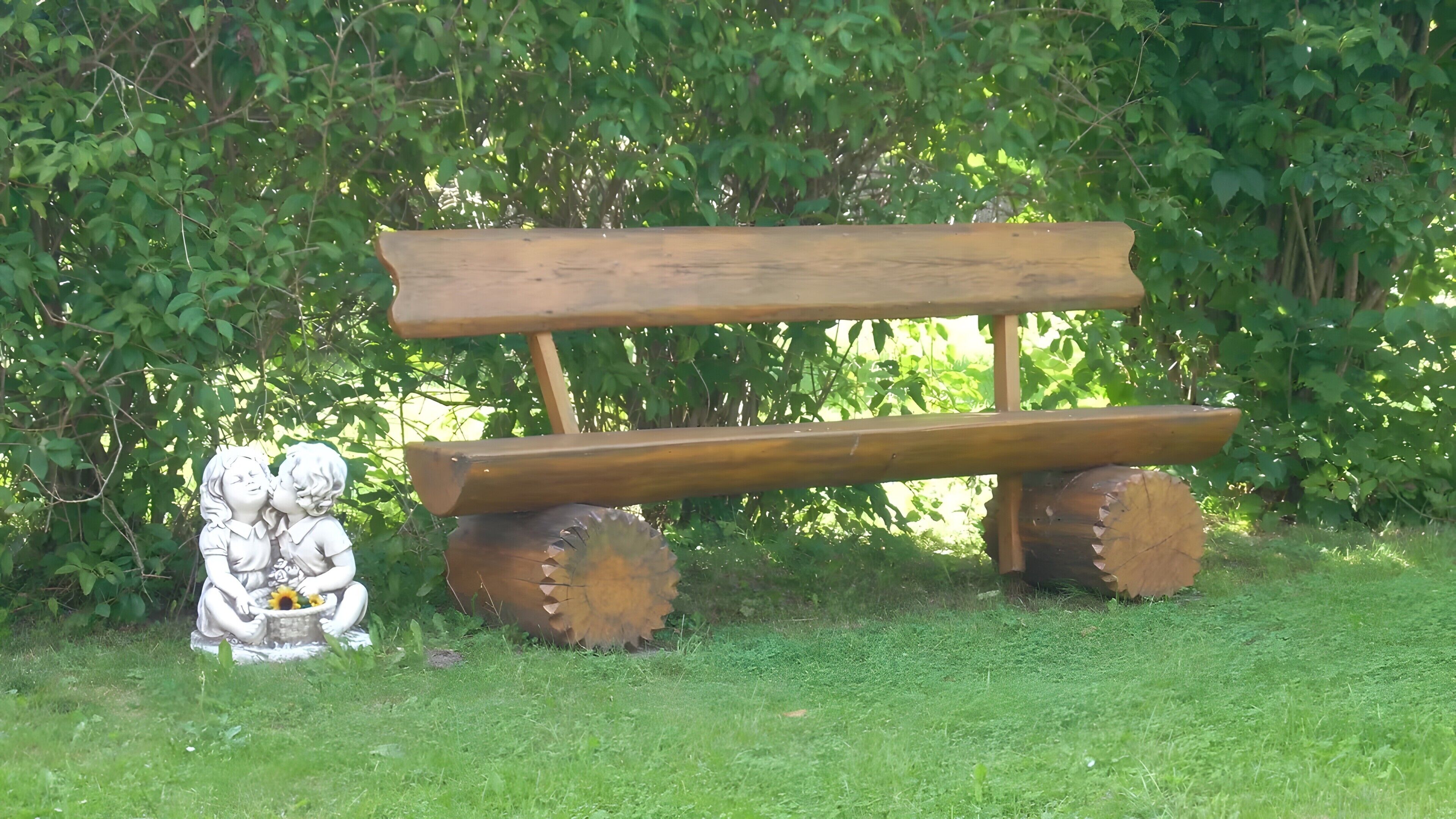 A wooden bench with a rustic design, surrounded by greenery.