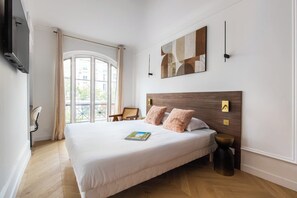 A hotel room with a large bed, a flat-screen TV, a painting, and a view through the window. - Luxurious apartment - 6 people - 11/12th floor (Paris)