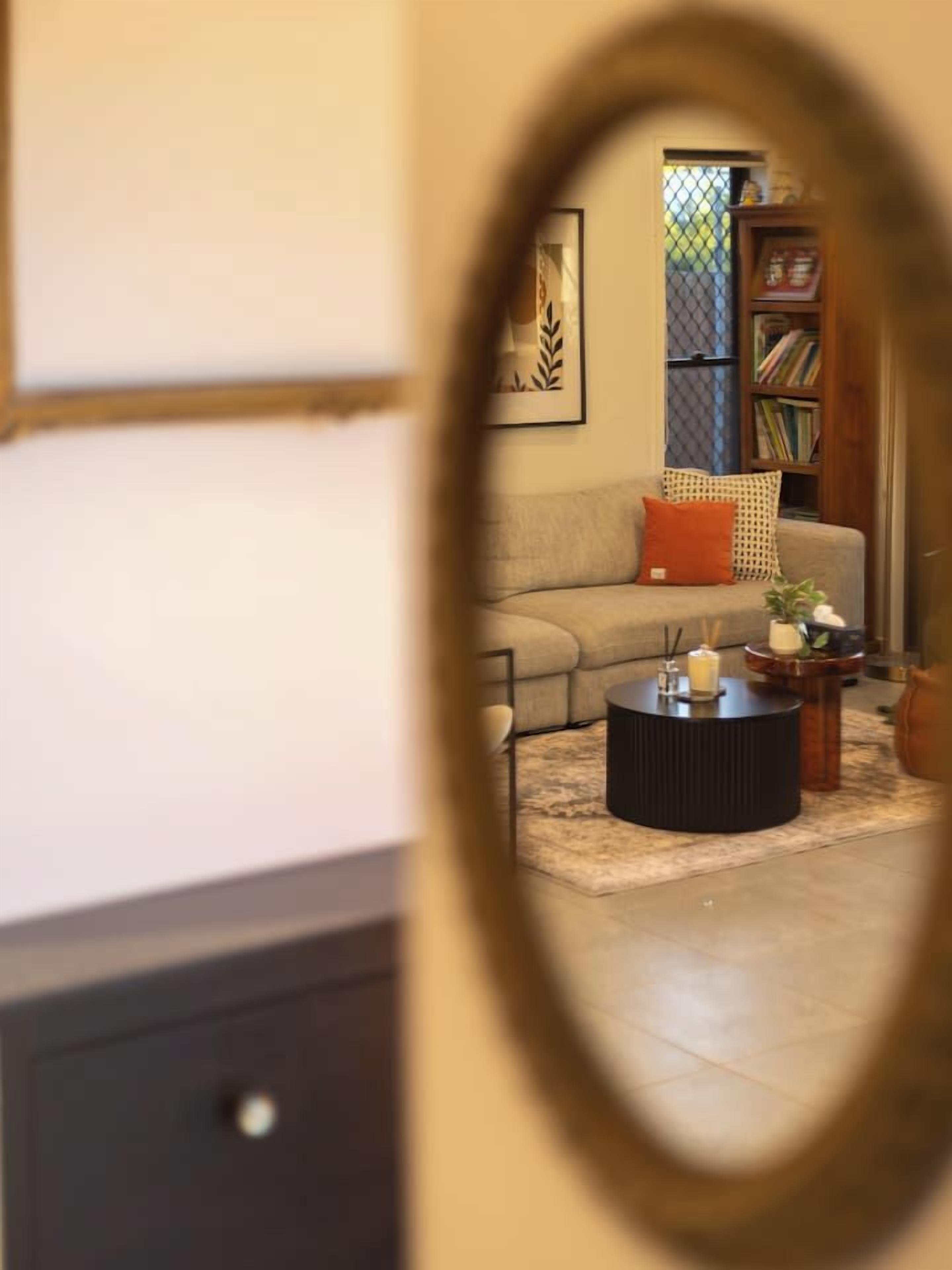 A living room with a sofa, a coffee table, and a bookshelf.