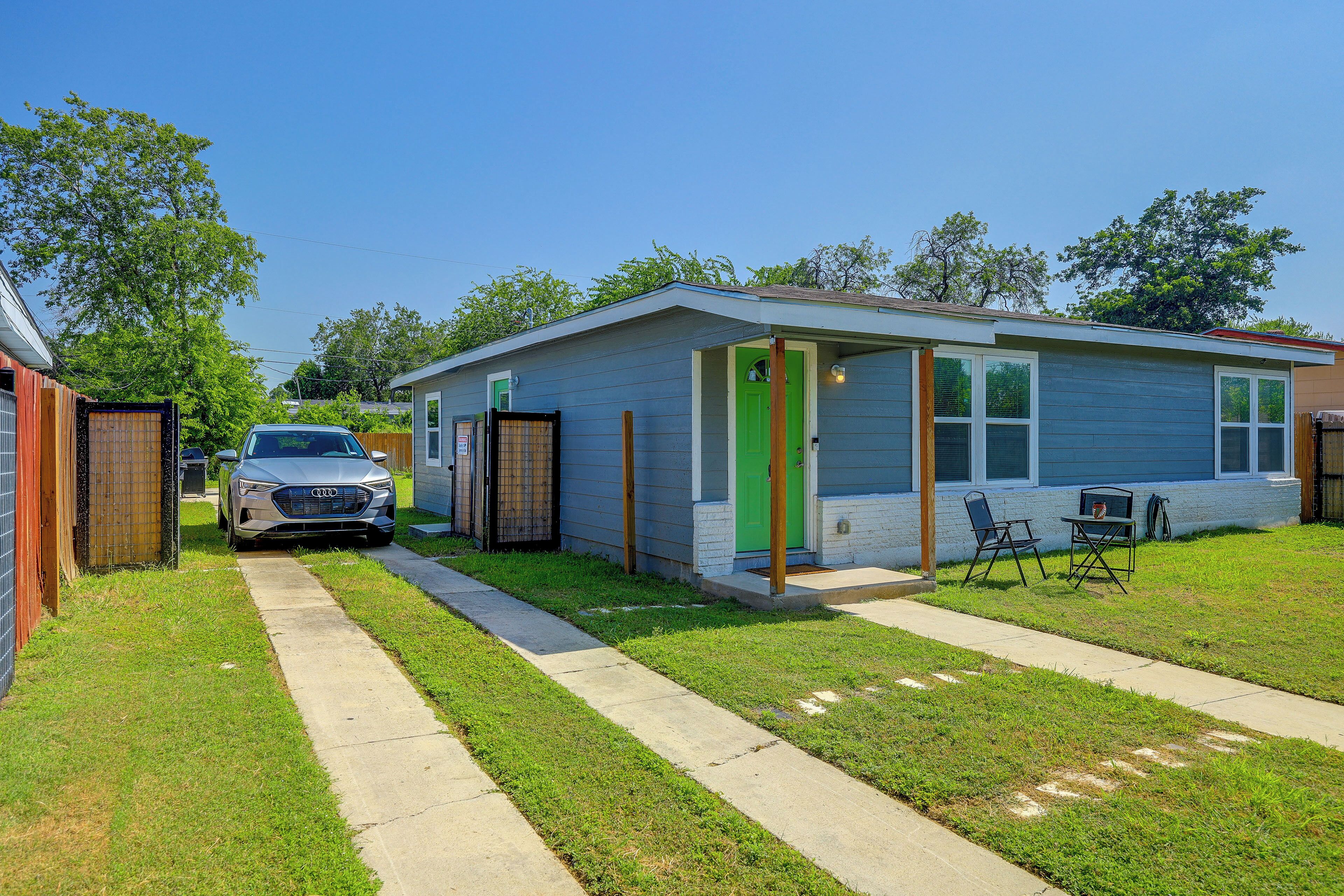 A single-story house with a visible garage door, a front door, and a small porch area.