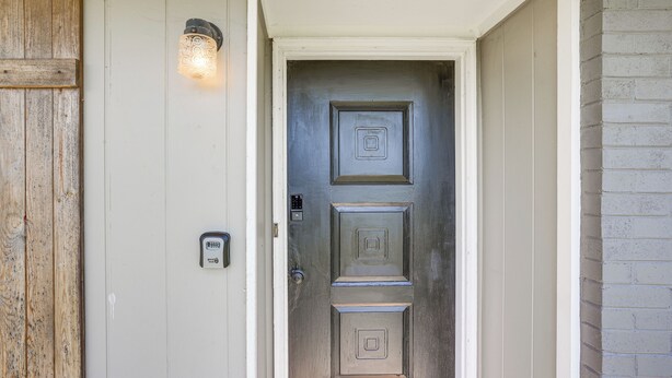 A door with a keypad lock, a light fixture above it, and a wooden panel to the left. - Minutes From Chattanooga / The Scenic City (Rossville)