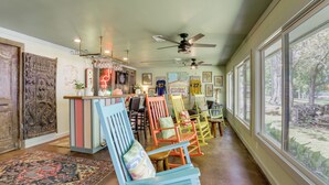 A room with a bar area, colorful chairs, a patterned rug, and large windows. - Tons of Fun at 'Camp Flamingo' on Lake Bruin! (St Joseph)