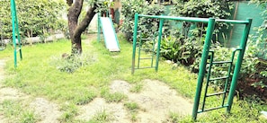 A playground with a slide and climbing structures. - La Savanna Resort And Spa By DL Hotels And Resorts (Ramnagar)