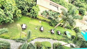 An aerial view of a hotel with a swimming pool, outdoor seating area, and lush greenery. - La Savanna Resort And Spa By DL Hotels And Resorts (Ramnagar)