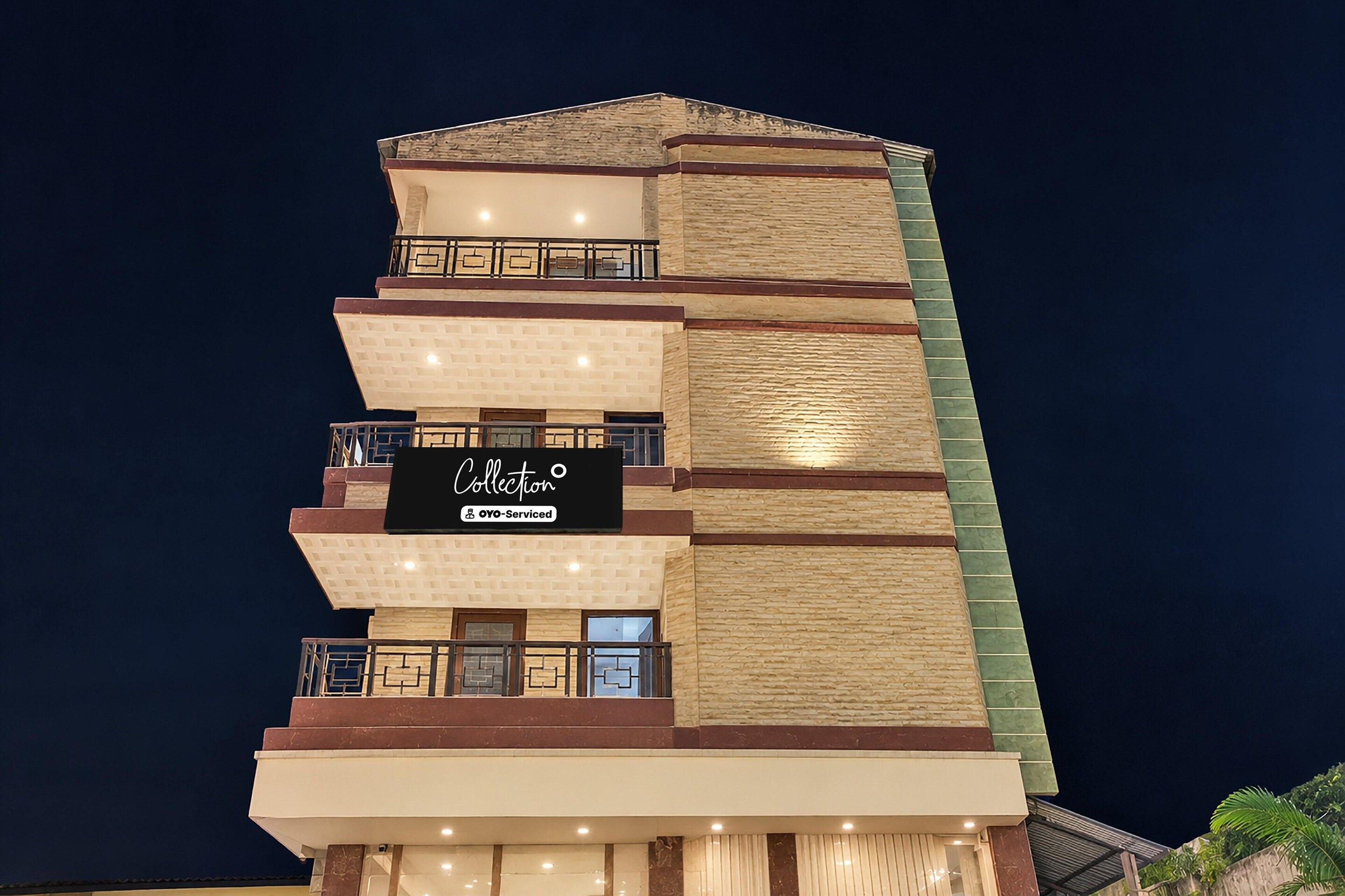 A multi-story building with a sign indicating it is serviced by OYO.