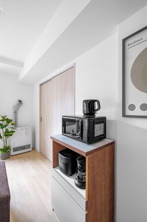 A kitchenette with a microwave, coffee maker, and a small refrigerator. - PREGARE 103 (Sapporoshi)