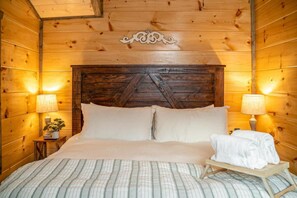 Bedroom Retreat: Rustic charm with warm wood accents and tranquil lighting for restful nights! - Fall Getaway | Dollywood | Hot Tub | Pets OK (Sevierville)