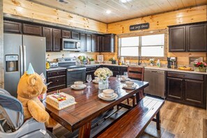 Kitchen & Dining Area: Gather around the rustic table for unforgettable meals and joyful laughter! - Fall Getaway | Dollywood | Hot Tub | Pets OK (Sevierville)
