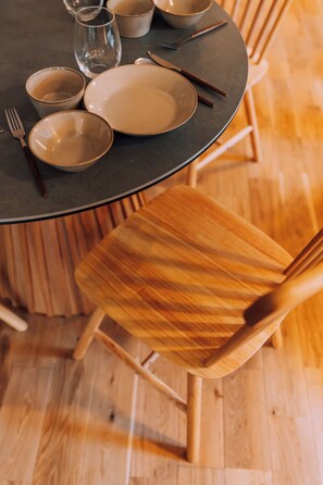 A round table with plates, bowls, and cutlery. There are wooden chairs around the table. - Hidden Playground Kagurazaka 3BR (Shinjuku City)