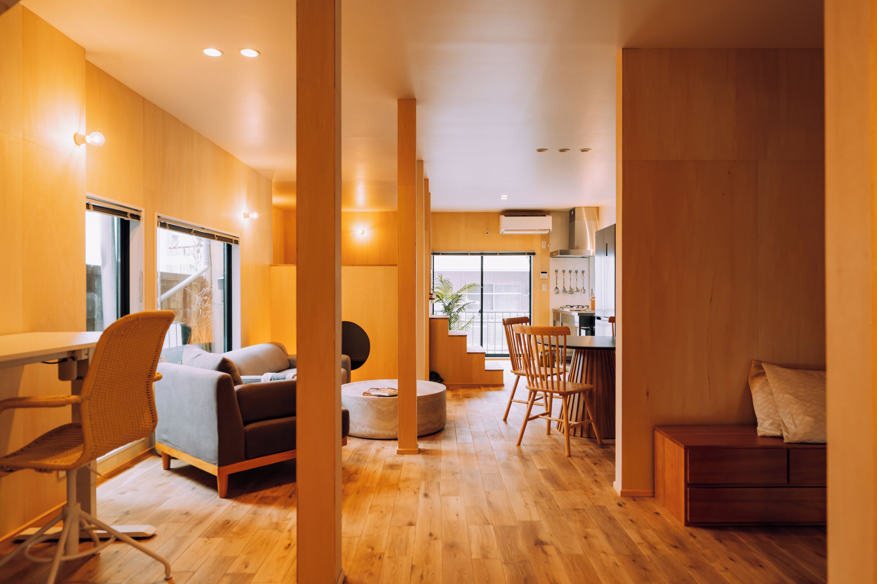 A modern interior with a dining area, seating, and a kitchen.