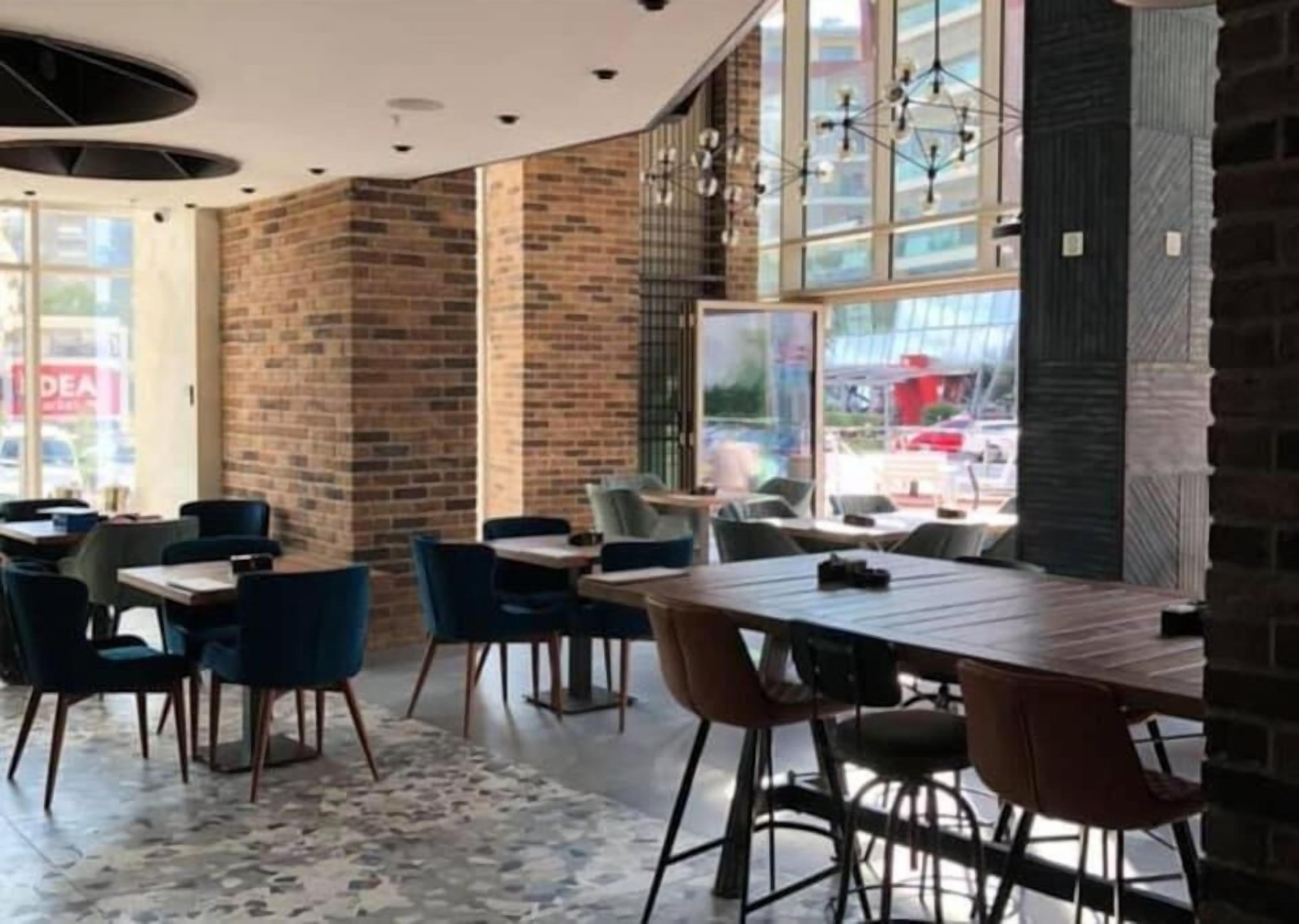 A modern interior with brick walls, large windows, and contemporary furniture.