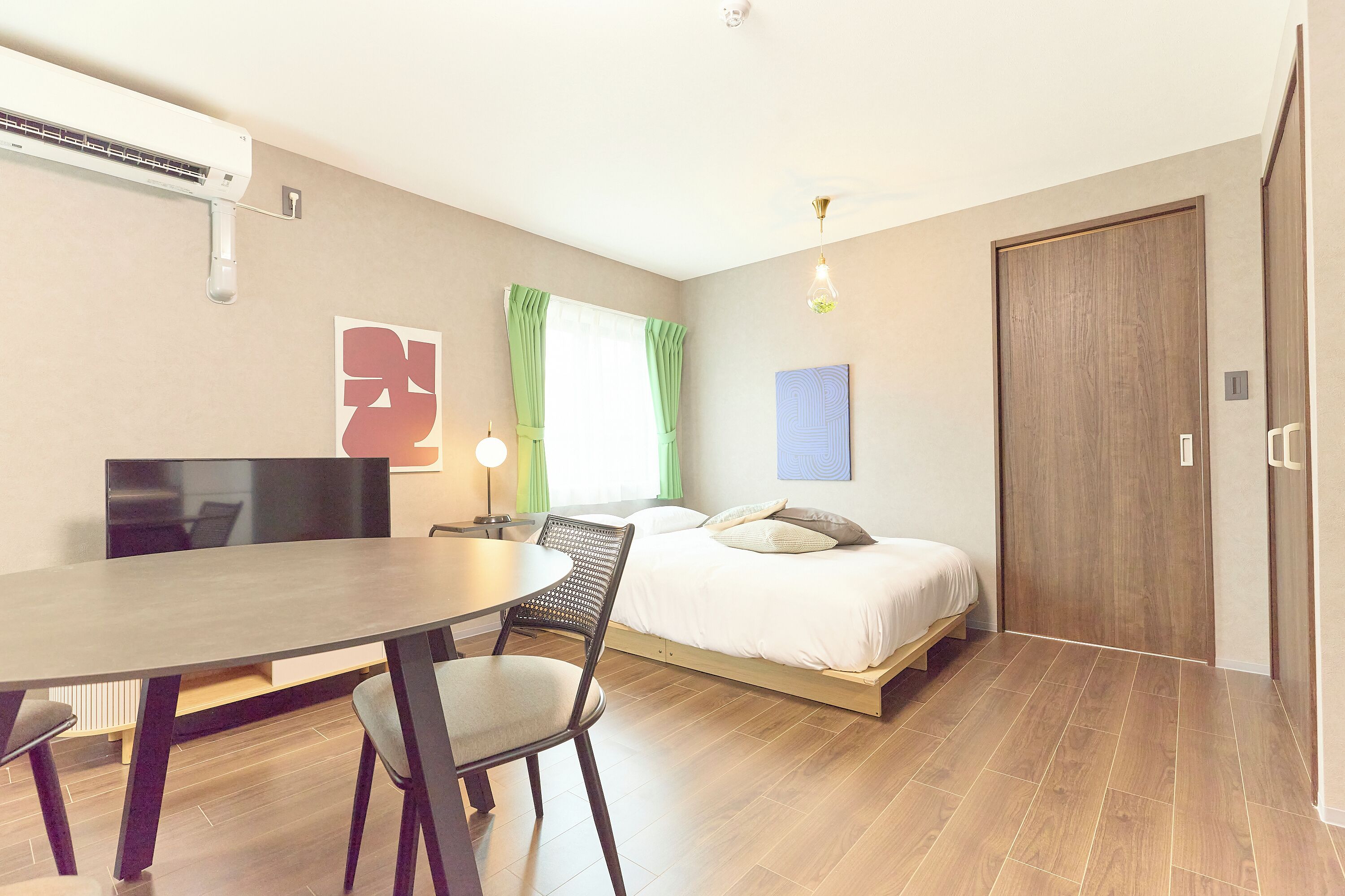 A modern bedroom with a bed, a desk, and a chair.