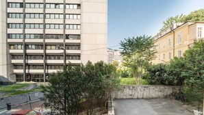 A multi-story building with a parking area, a bicycle, and a staircase. - GuestHost - Comfy Flat X4 Near the Center (Trieste)