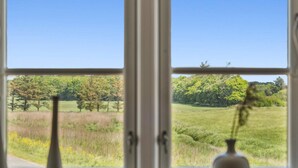 A window with a view of a grassy field and trees. - 5 Star Holiday Home in Tonder (Tonder)