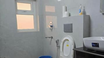 Family Studio, Garden View | Bathroom | Shower, free toiletries, hair dryer, slippers