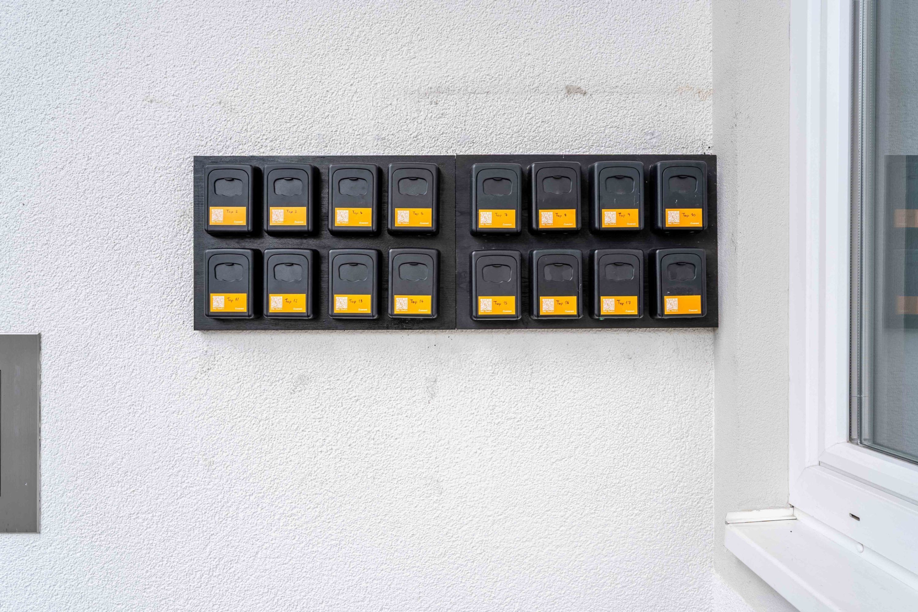 A wall-mounted panel with multiple switches.