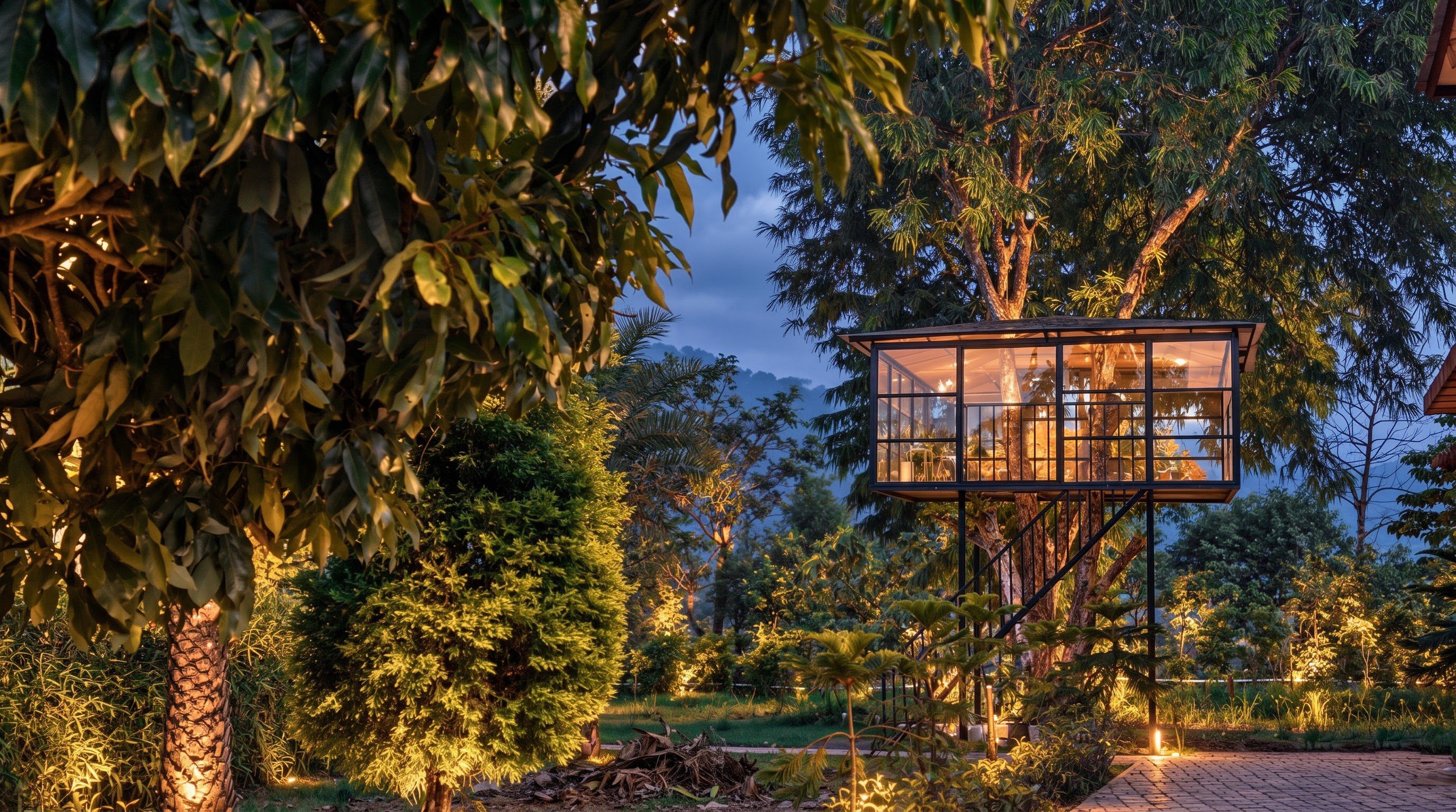 A treehouse with a glass enclosure, surrounded by dense foliage and trees.