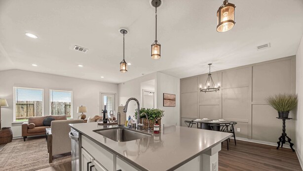 A spacious kitchen with a central island, pendant lighting, and a dining area with a chandelier. - Texas Crew Retreat:4BR, Huge Parking & TVs (Cove)