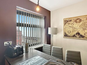 A modern kitchen with a window, a map on the wall, a lamp, and a toaster. - BK302 Billow - UKC9592 (Blackpool)