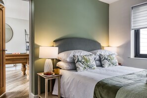 A bedroom with a bed, bedside lamps, a nightstand, and a window. - 2 Pier Avenue - Whitstable , Kent (Whitstable)