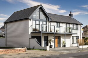 A two-story house with a balcony, a front door, and a chimney. - 2 Pier Avenue - Whitstable , Kent (Whitstable)