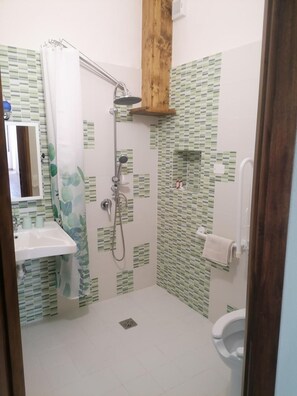 Ein Badezimmer mit Dusche, Waschbecken und Toilette.