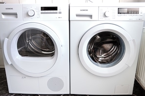 Two white Siemens front-loading washing machines side by side.