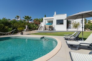 Ein Schwimmbad mit Liegestühlen und einer Terrassenanlage.