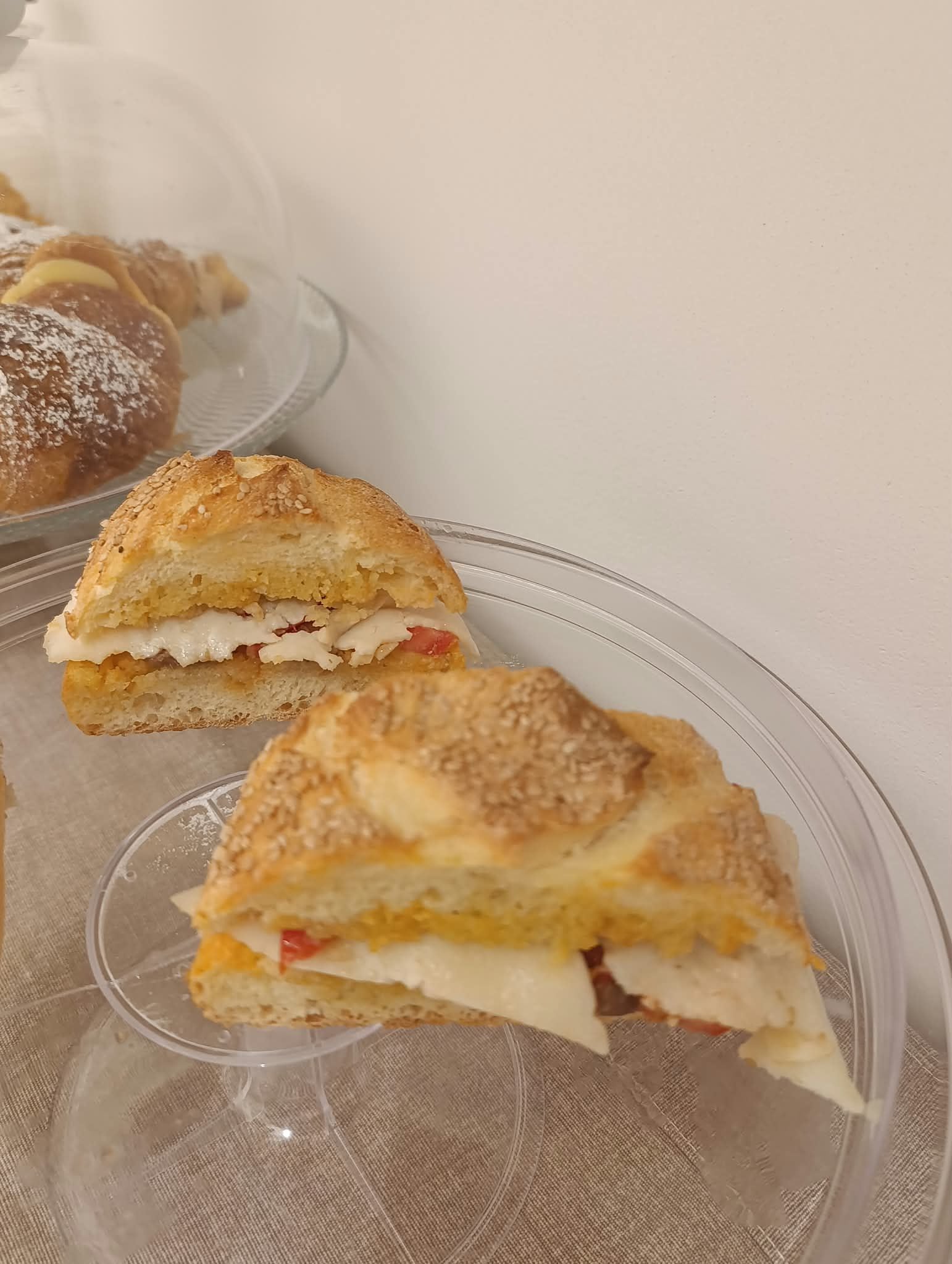A sandwich on a clear glass plate.