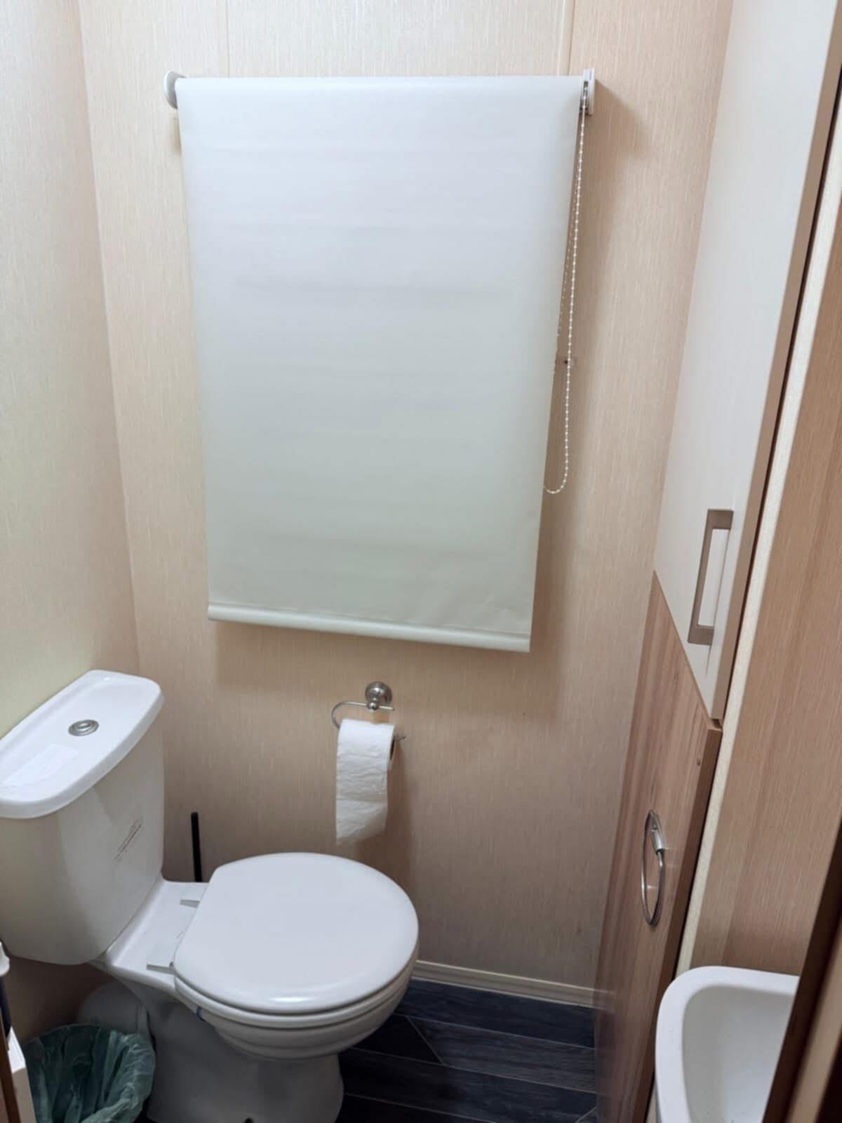 A small bathroom with a toilet, a sink, and a bidet.