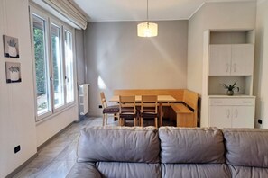 A modern kitchen with a dining table, chairs, and a pendant light. - In the Como Borghi Area (Ganymede Apartment) (Como)